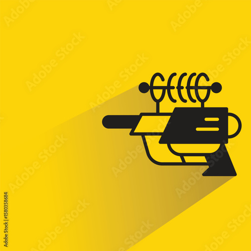 space gun with shadow on yellow background