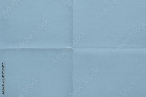 Light blue paper with fold lines and crease details as abstract background