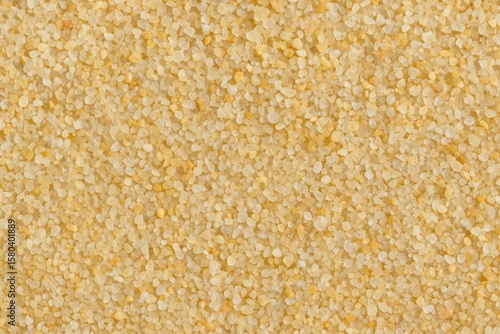 Close-up of textured coarse sand particles on a tropical-themed backdrop