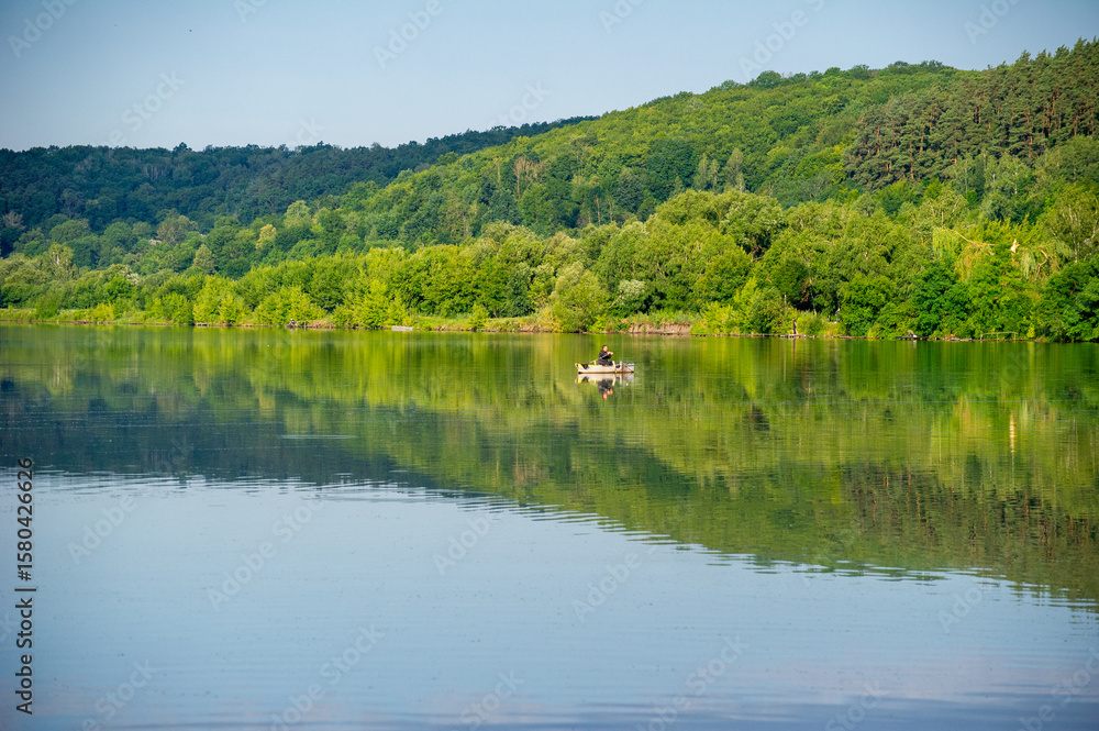Fototapeta premium reflection of trees in the water of lake in the mountains