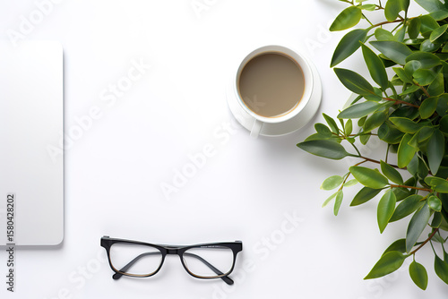 Designer desk layout showcasing a laptop smartphone and office essentials from a top angle