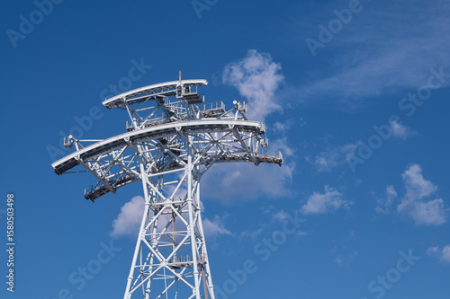Wallpaper Mural Cableway tower against the background of the sky with clouds. The support made of metal structures under construction. View from below. Torontodigital.ca