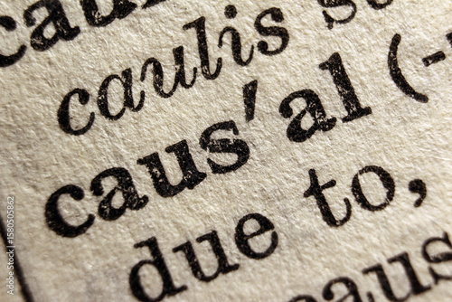 Word causal on dictionary page, macro close-up	
