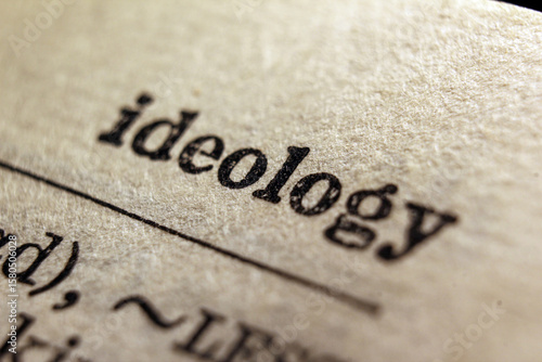 Word ideology on dictionary page, macro close-up	
