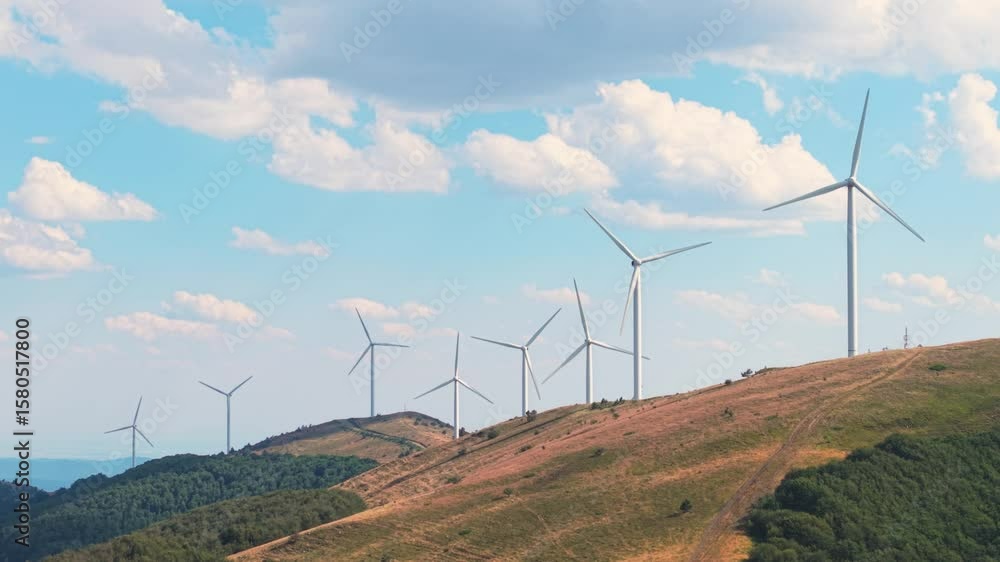 Flying Over Wind Turbines in Bulgaria Balkan Range with Fluffy Clouds Overhead Flying Over Wind Turbines in Bulgaria Balkan Range with Fluffy Clouds Overhead