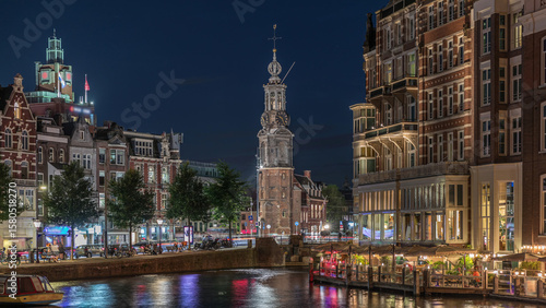 Canvas Print Panoramic night timelapse of Amsterdam city center featuring Amstel River, waterfront and Munttoren tower