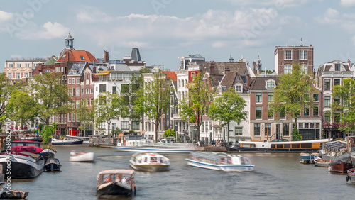 Photography Timelapse of a busy river in Amsterdam's city center on a sunny day