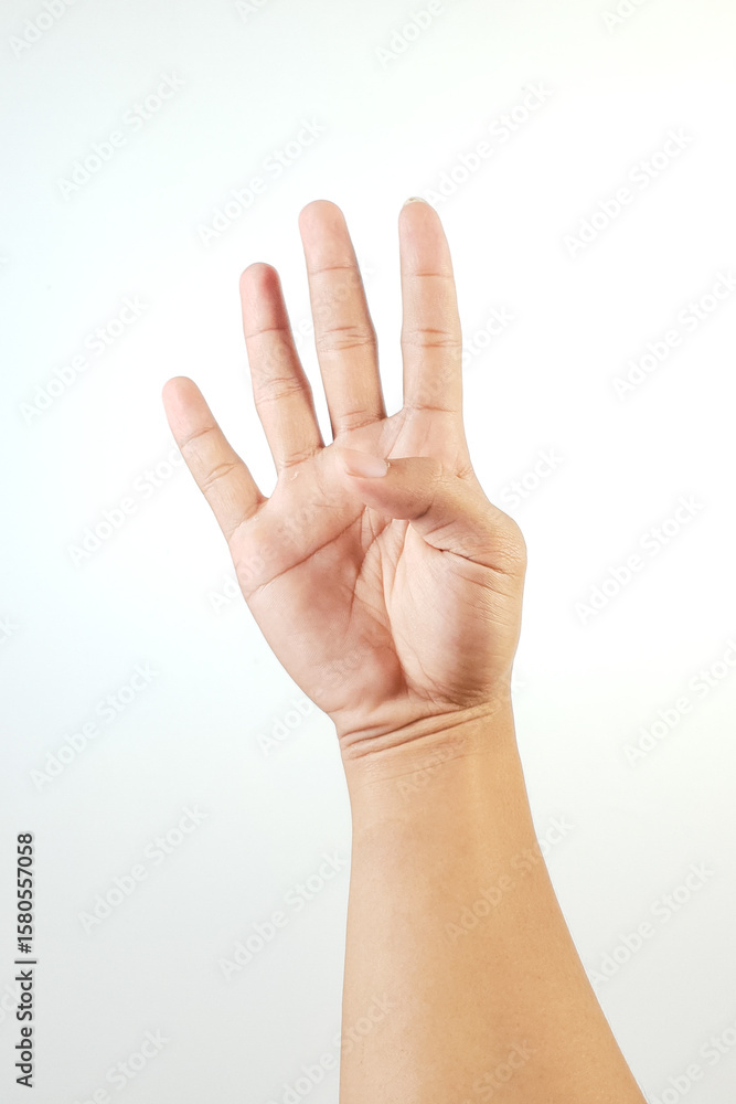 A hand making a gesture showing the number four using fingers, against a white background A hand making a gesture showing the number four using fingers, against a white background