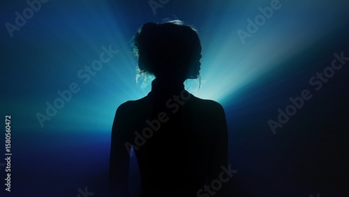 Wallpaper Mural Silhouette of woman with radiating blue light beams Torontodigital.ca