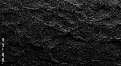 Close-up view showcasing a textured, dark, and rugged surface of slate rock.