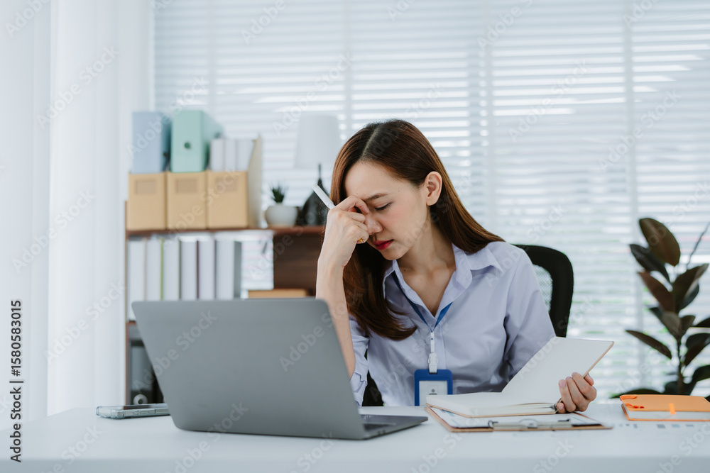 Asian businesswoman or female office worker who is angry, irritated, stressed over a failed job. and crumpled documents in her hands at her desk. Depression overworked Office Syndrome. Asian businesswoman or female office worker who is angry, irritated, stressed over a failed job. and crumpled documents in her hands at her desk. Depression overworked Office Syndrome.