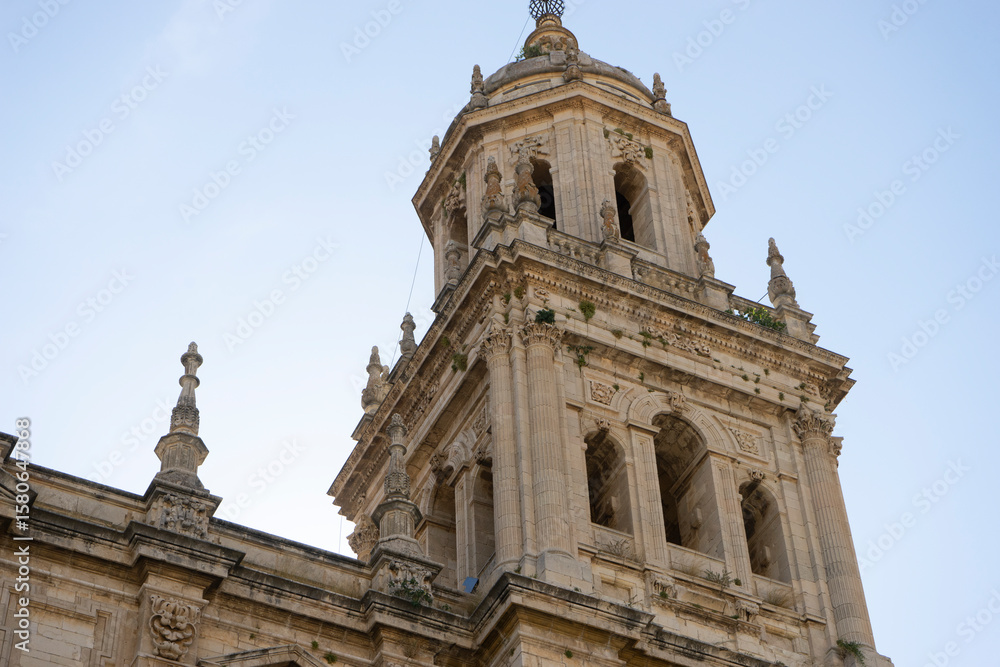 Exploring the historic tower of Santa Iglesia Catedral in Jaen, Andalucia, showcasing intricate detail against a clear sky Exploring the historic tower of Santa Iglesia Catedral in Jaen, Andalucia, showcasing intricate detail against a clear sky