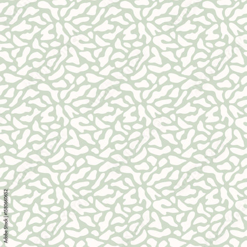 Abstract vector organic pattern. Minimal seamless texture with organic cut-out shapes, spots, cells. Simple trendy background. Light green color. Repeated design for print, decor, wallpaper, textile