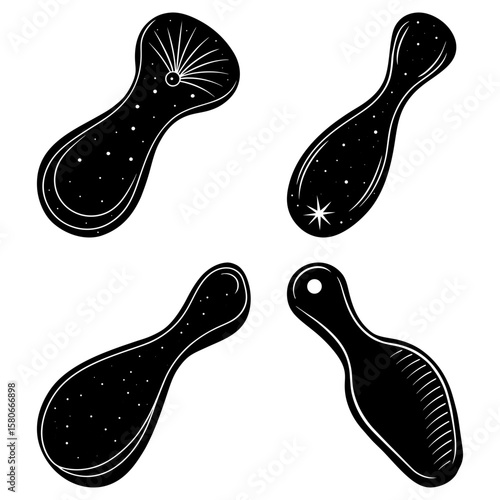 Four black and white stylized pendants with celestial designs and unique shapes displayed together nicely