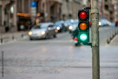 traffic light on the street junction with beautiful bokeh, city with cars in the background