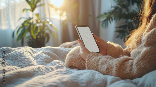 Woman relaxing at home using laptop and tablet on sofa for casual online browsing and communication
