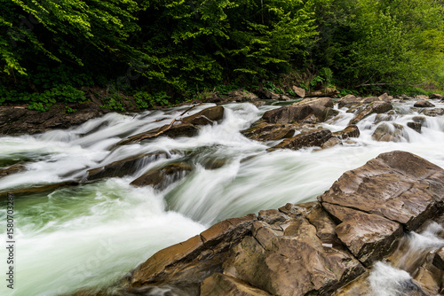 Wild river flowing through rocks in Bieszczady Mountains