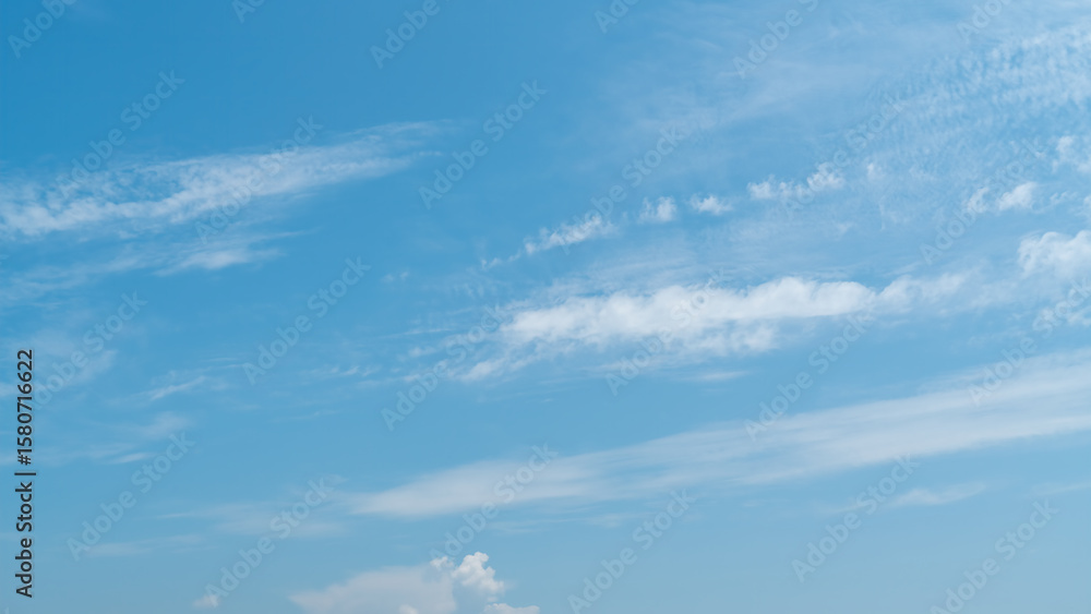 Fototapeta premium Clear Blue Sky with Some Wispy Clouds Floating
