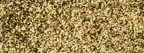 A shiny and textured glitter surface in a warm golden hue, offering a seamles...