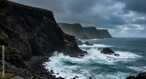 Rocks and cliffs along a rugged coastline with crashing waves and a dramatic sky in the background, concept of raw nature, scenic power, and coastal beauty.