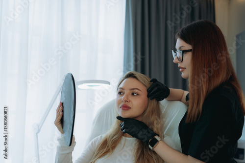 woman aesthetic doctor at personalized anti-aging consultation with a young female client