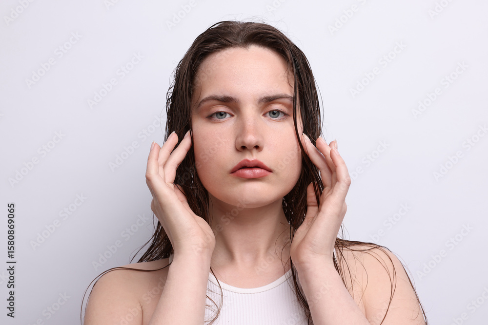 Fototapeta premium Portrait of beautiful woman with natural skin complexion on light grey background, closeup