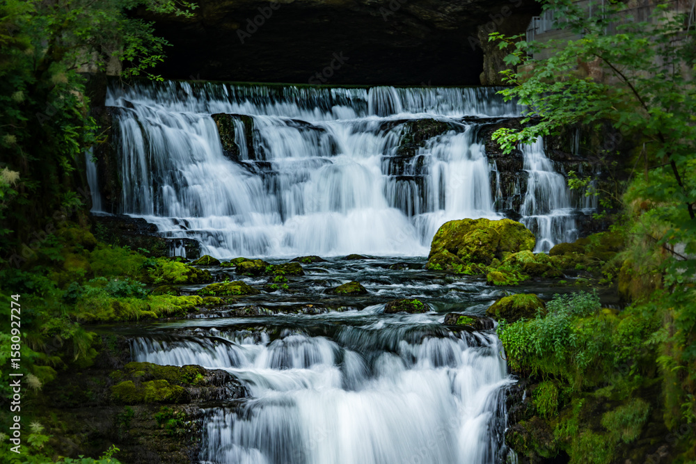 Long exposure shot of waterfall at the Source du Lisonin the Jura, France Long exposure shot of waterfall at the Source du Lisonin the Jura, France