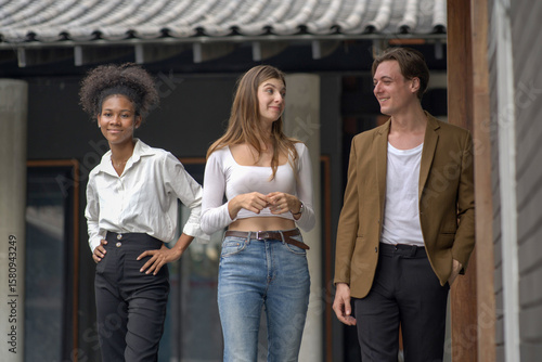 Diverse young adults bonding during a walk in a stylish environment