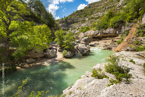 Gorges de la Meouge in summer, Hautes-Alpes. Turquoise river, rocky cliffs, and lush greenery in Baronnies Provencales Regional Nature Park. Southern French Alps, France