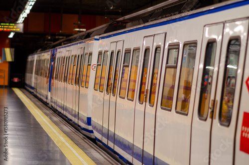 A modern metro train stands at an empty underground platform, ready for passengers. Urban transportation, public transit and city infrastructure concept.
