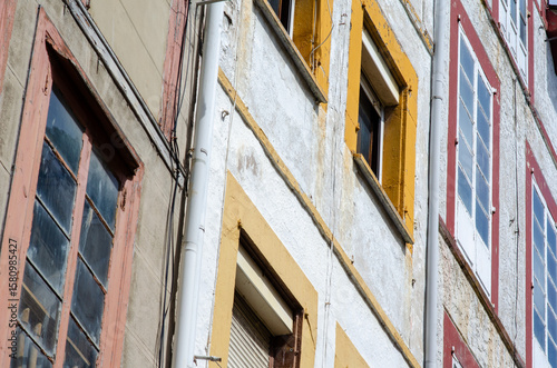 Historic European architecture featuring aged walls and vibrant window frames; urban atmosphere with weathered textures and authentic details for design projects.