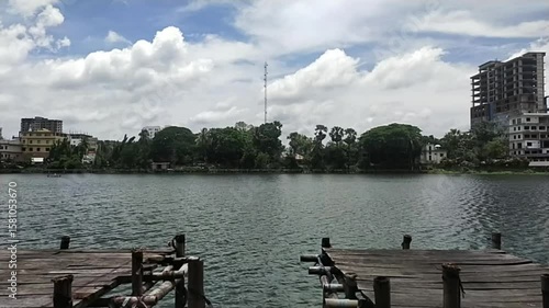Time-Lapse of Urban Lakefront Pier with Cityscape and Clouds Movement