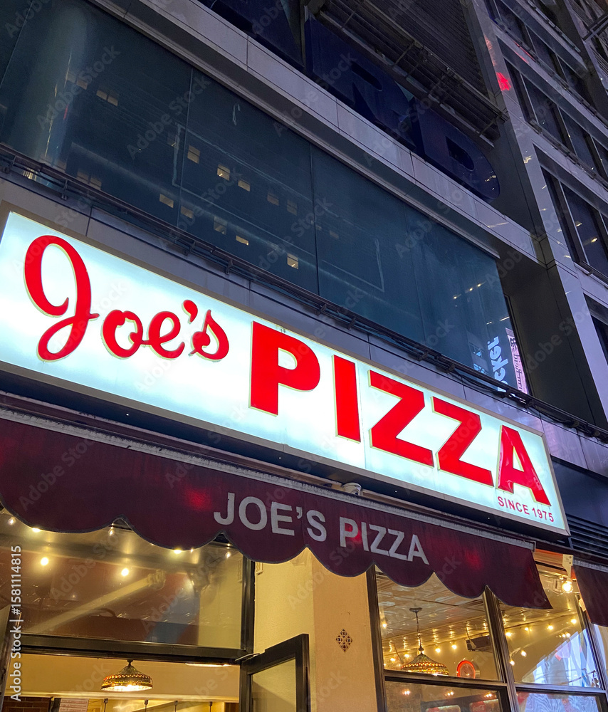 Naklejka premium New York City, USA, April 1, 2024: Joe's Pizza building façade in Greenwich Village, NYC. Established in 1975 by Joe Pozzuoli.