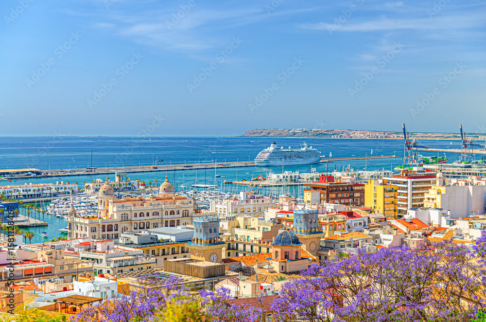 Fototapeta premium Aerial panoramic view of old town Alicante, panorama of Alicante city historic centre, centro Alacant, Port of Alicante with cruise ship in Bahia de Alicante bay of Mediterranean Sea horizon, Spain