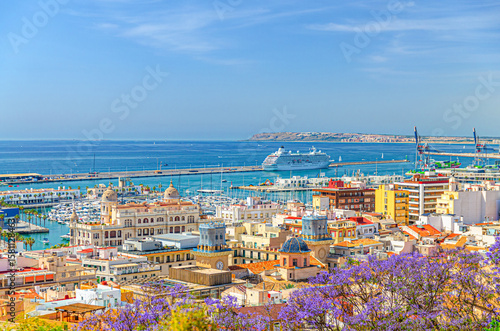 Aerial panoramic view of old town Alicante, panorama of Alicante city historic centre, centro Alacant, Port of Alicante with cruise ship in Bahia de Alicante bay of Mediterranean Sea horizon, Spain