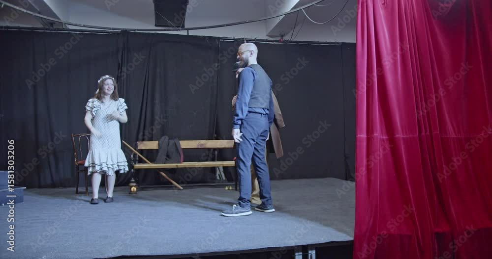 Young actors rehearse a play on stage. They walk, talk, and interact ...