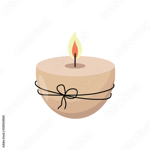 Beige round candle with lit flame wrapped in black string tied in a bow on white background