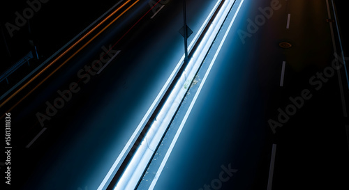 Illuminated Highway At Night With Streaking Headlights And Abstract Traffic Motion
