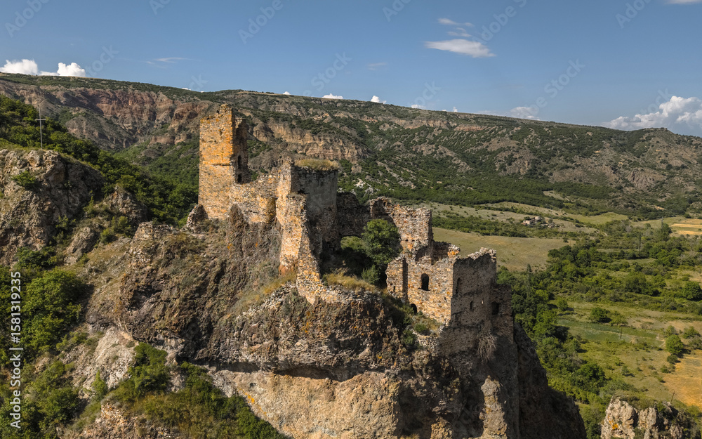 Fototapeta premium Aerial view of Ruins of Drisi Fortress in Georgia with panoramic mountain and valley views