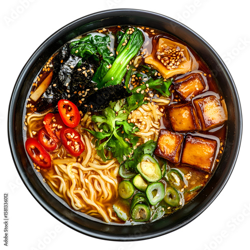 Delicious and vibrant ramen bowl with tofu seaweed chili peppers bok choy and sesame seeds in a black bowl top view