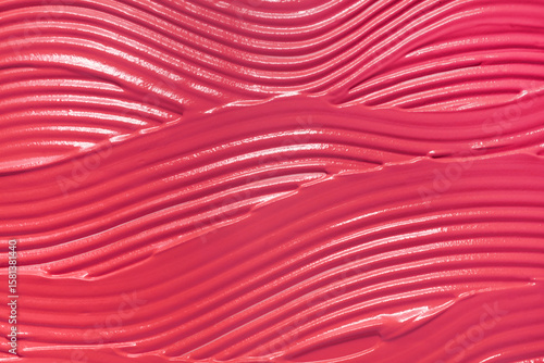 Pink matte or satin finish smeared liquid creamy lipstick background texture nude blusher sample swatch