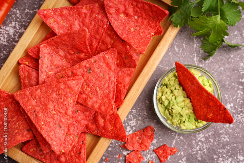 Wooden tray with red nachos...