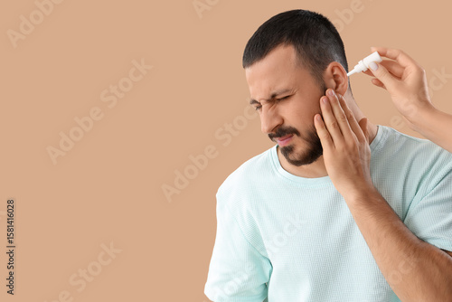 Woman putting drops in youn...