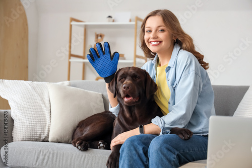 Young woman with pet glove ...