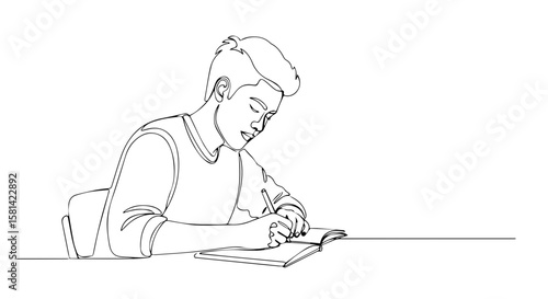 Young boy writing in notebook while sitting at a table indoors  