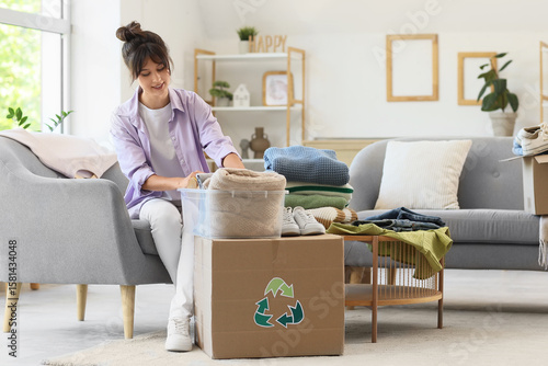 Young woman packing clothes...
