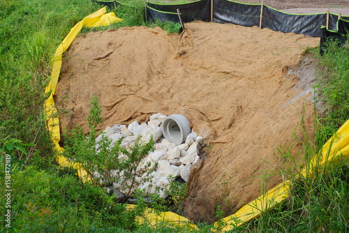 Fototapeta Sediment Control Basin with Erosion Prevention Measures in a Grassy Environment