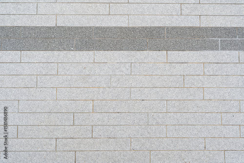 Modern Grey Brick Wall with Stripe. modern brick wall or paving made of light grey rectangular bricks. neutral background or a subtle architectural detail, suitable for various design, construction.