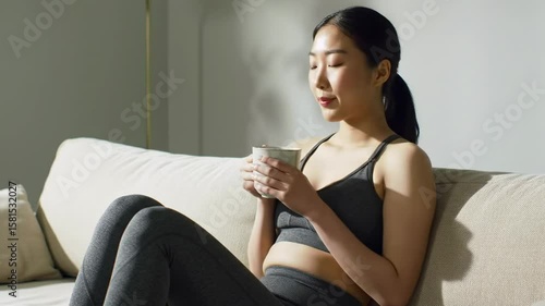 Woman drinking coffee on couch