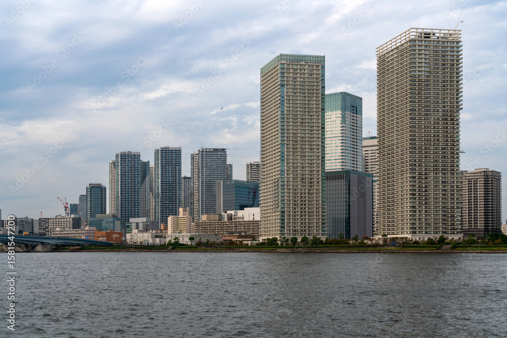 Naklejka premium Harumiohashi Bridge and district of Chuo Harumi on reclaimed land, created by dropping earth and sediment generated from expanding Tokyo Bay, Tokyo, Japan